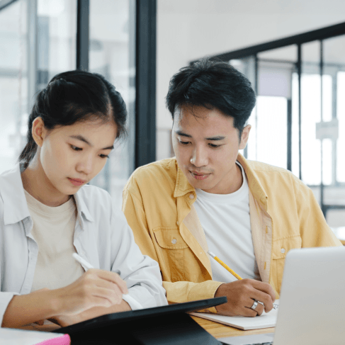 Two students check a translated transcript packet, using Chinese Translation Services in Virginia for academic admissions.