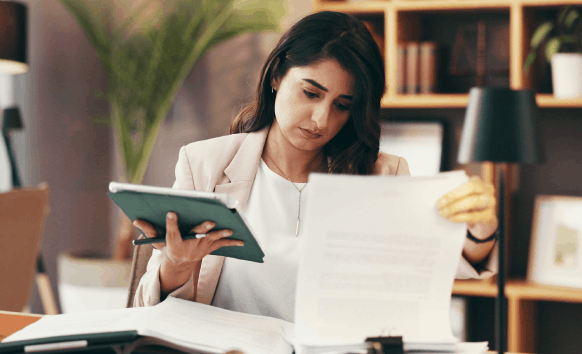 A translator reviews a certified translation packet at a desk, showing Translation Services in Richmond for official use.