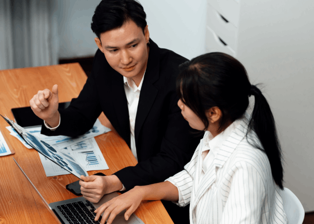 A finance team reviews an annual report with Vietnamese Translation Services in Virginia for compliant financial document.