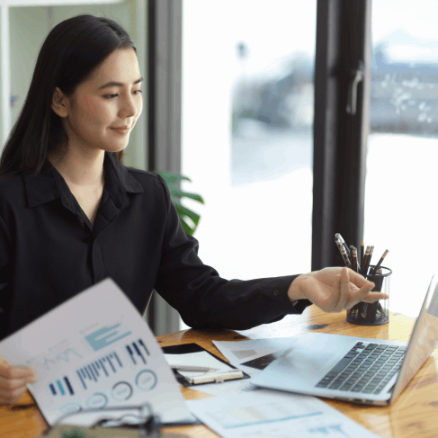 An accountant checks a certified Korean annual report translation, using Korean Translation Services in Virginia for review.