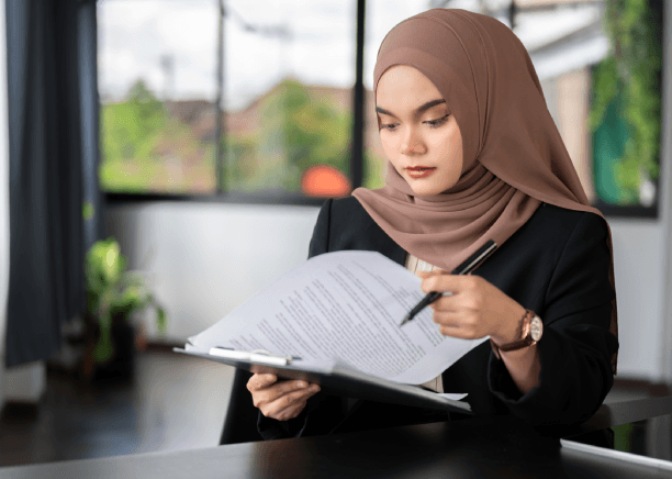 A translator providing certified diploma translation for Arabic Translation Services in Virginia at a desk.