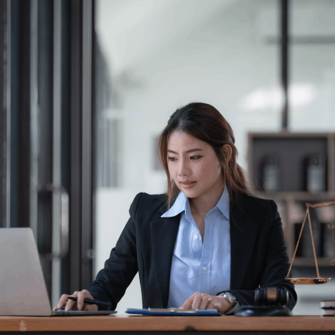 A lawyer reviews a translated motion on a laptop, using Translation Services in Richmond for legal purposes.