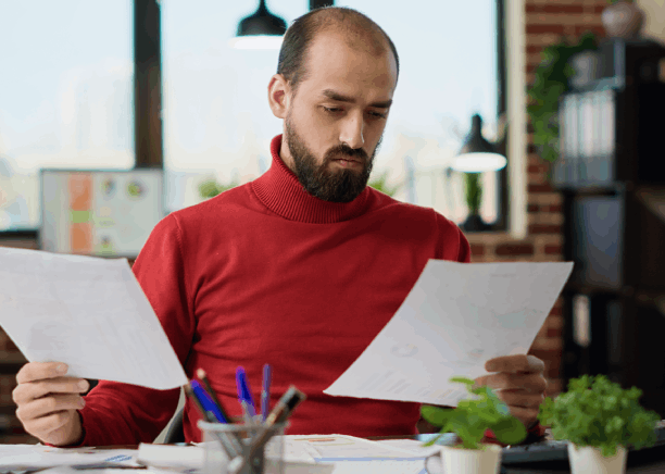 A person reviews a translated legal form side by side with the original for Spanish Translation Services in Virginia at home.