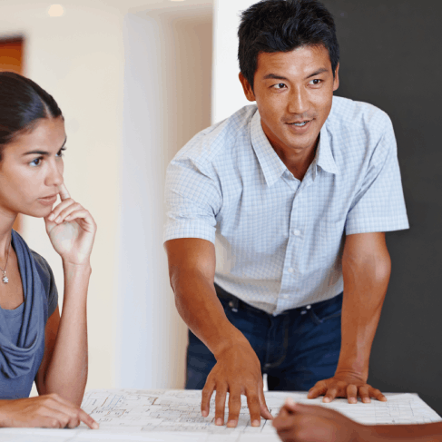 A realtor reviews a purchase agreement as Vietnamese Translation Services in Virginia prepare a real estate document packet.