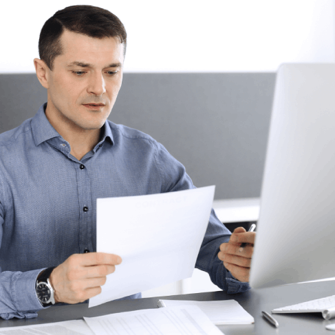 A customer reviews a bilingual property contract at a desk, using Translation Services in Richmond for real estate closings.
