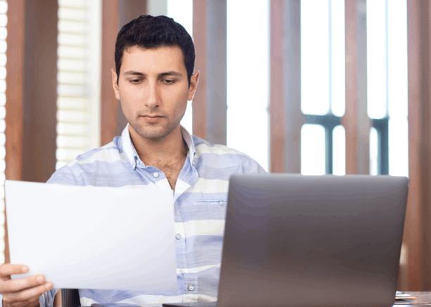 A project manager marks edits on a translated business contract, showing Translation Services in Richmond for deal terms.